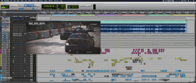 Screenshot of Pro Tools with an open session, showing the audio timeline and a video of a car racing game